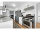 Updated kitchen featuring stainless steel appliances, granite countertops and an open layout at 1924 Yosemite St, Denver, CO 80220