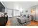 Inviting living room with hardwood floors, a gray sectional and wall paint, and soft natural lighting at 1924 Yosemite St, Denver, CO 80220
