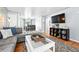 Open living space with hardwood floors and gray walls flowing into a dining area with seating for four at 1924 Yosemite St, Denver, CO 80220
