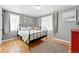 Spacious main bedroom with hardwood floors, two windows, and a decorative mirror at 1924 Yosemite St, Denver, CO 80220