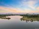 Scenic aerial view of community featuring a tranquil lake with walking paths, promising an active lifestyle at 3039 W 22Nd Ave, Denver, CO 80211