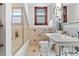 Bathroom with tub and shower, patterned tile, and wooden trim at 3039 W 22Nd Ave, Denver, CO 80211