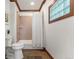 Cozy bathroom with tub, shower, tiled walls, and unique glass block window at 3039 W 22Nd Ave, Denver, CO 80211