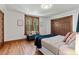 Bedroom with window bench, wood trim and floors, and closet with decorative wood doors at 3039 W 22Nd Ave, Denver, CO 80211