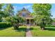 Charming home with a covered front porch and mature landscaping along a stone walkway at 3039 W 22Nd Ave, Denver, CO 80211