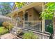 Inviting front porch with cozy seating and classic decorative details on posts and railings at 3039 W 22Nd Ave, Denver, CO 80211
