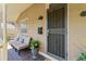 Welcoming front porch featuring comfortable seating and a secure, decorative metal screen door at 3039 W 22Nd Ave, Denver, CO 80211
