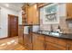 Well-lit kitchen featuring granite countertops, natural wood cabinets and stainless steel appliances at 3039 W 22Nd Ave, Denver, CO 80211
