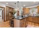 Well-appointed kitchen featuring a large island with counter seating and beautiful wood cabinetry at 3039 W 22Nd Ave, Denver, CO 80211