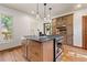Bright kitchen island with granite countertop, stainless steel range and natural wood cabinets at 3039 W 22Nd Ave, Denver, CO 80211