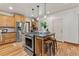 Open kitchen featuring a center island with seating, stainless appliances, and sleek countertops at 3039 W 22Nd Ave, Denver, CO 80211