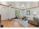 Bright living room features hardwood floors, stylish seating, and a decorative stained glass window at 3039 W 22Nd Ave, Denver, CO 80211