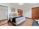 Comfortable main bedroom with hardwood floors, wood trim, and a decorative mirror at 3039 W 22Nd Ave, Denver, CO 80211