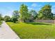 Expansive lawn surrounds this inviting home, complemented by mature trees and a privacy fence at 3039 W 22Nd Ave, Denver, CO 80211