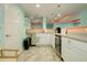 Basement kitchenette with white cabinets and modern appliances at 10256 Olathe Way, Commerce City, CO 80022