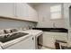 Laundry room with washer, dryer, and ample cabinet space at 10256 Olathe Way, Commerce City, CO 80022