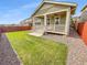 Private backyard with a covered patio and lush lawn, perfect for outdoor entertaining and relaxation at 14880 Chicago St, Parker, CO 80134