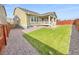 Lush backyard with lawn, garden beds, mature trees, and privacy fence, perfect for outdoor enjoyment at 14880 Chicago St, Parker, CO 80134