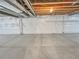 Spacious unfinished basement, primed for customization, featuring concrete flooring and exposed ceiling at 14880 Chicago St, Parker, CO 80134