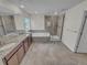 Bright bathroom featuring double vanity, large soaking tub, a glass-enclosed shower, and tile flooring at 14880 Chicago St, Parker, CO 80134