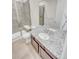 Modern bathroom with a glass enclosed shower, granite countertops and vanity, and tile flooring at 14880 Chicago St, Parker, CO 80134