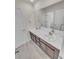 Bathroom featuring a double sink, marble countertop, and dark wood cabinetry at 14880 Chicago St, Parker, CO 80134