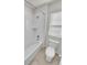 This bathroom features a shower and tub combo with tiled walls and a standard toilet at 14880 Chicago St, Parker, CO 80134