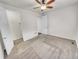 Bright bedroom featuring neutral carpeting, a lighted ceiling fan, and a walk-in closet at 14880 Chicago St, Parker, CO 80134