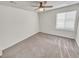 This bedroom is bright and neutral, has carpet, a ceiling fan, and a window at 14880 Chicago St, Parker, CO 80134