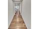 Long hallway featuring wood flooring and neutral walls, connecting the main areas of the home at 14880 Chicago St, Parker, CO 80134