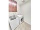 Convenient laundry room equipped with modern appliances and storage cabinet above at 14880 Chicago St, Parker, CO 80134