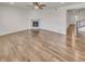 Bright living room with wood floors, a ceiling fan, and a modern fireplace at 14880 Chicago St, Parker, CO 80134