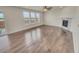 Spacious living room with beautiful hardwood floors, ample natural light, and a cozy fireplace at 14880 Chicago St, Parker, CO 80134