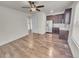 Open floorplan featuring hardwood-style floors and a galley kitchen with stainless refrigerator at 14880 Chicago St, Parker, CO 80134