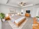 Stylishly staged main bedroom with a tray ceiling, ceiling fan, and bright, neutral colors at 14880 Chicago St, Parker, CO 80134