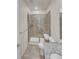 Contemporary tiled shower with glass doors, built in bench seating and updated fixtures at 14880 Chicago St, Parker, CO 80134