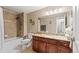 Well-lit bathroom features a granite countertop, tile backsplash, and a shower-tub combination at 430 Zang St # 4-103, Lakewood, CO 80228