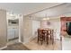Cozy dining area features a wooden table, stylish chandelier, and adjacent laundry closet for added convenience at 430 Zang St # 4-103, Lakewood, CO 80228