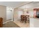 Dining area adjacent to kitchen features tile floors, bar seating and a view of the kitchen at 430 Zang St # 4-103, Lakewood, CO 80228