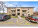 Well-maintained building exterior with balconies and assigned parking spaces for residents at 430 Zang St # 4-103, Lakewood, CO 80228