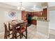 Bright kitchen featuring tile floors, dark cabinets, and a black refrigerator, open to the dining area at 430 Zang St # 4-103, Lakewood, CO 80228