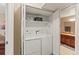 Bright laundry room featuring side by side washer and dryer and access to the bathroom at 430 Zang St # 4-103, Lakewood, CO 80228