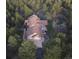 Aerial view of the home surrounded by lush trees, showing roof and driveway at 7076 Boreas Rd, Larkspur, CO 80118