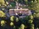 Aerial view of the home showcasing lush trees, roofing, and an outdoor area at 7076 Boreas Rd, Larkspur, CO 80118
