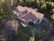 Aerial shot of the home featuring a deck and lush landscaping, with a yard at 7076 Boreas Rd, Larkspur, CO 80118