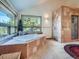 Corner tub with tile surround and a walk in shower, illuminated by natural light from a nearby window at 7076 Boreas Rd, Larkspur, CO 80118