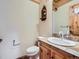 Powder room with custom vanity, tile countertop and unique rustic details at 7076 Boreas Rd, Larkspur, CO 80118