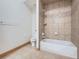A bathroom features a tub and shower with tiled walls, vanity and fixtures at 7076 Boreas Rd, Larkspur, CO 80118