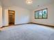A large bedroom with neutral colors, bright light from a window, and closet for storage at 7076 Boreas Rd, Larkspur, CO 80118