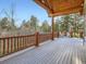 Expansive deck with log railing offering scenic wooded views at 7076 Boreas Rd, Larkspur, CO 80118